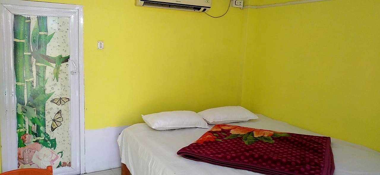 Cottage bedroom featuring split AC and fresh bedding
